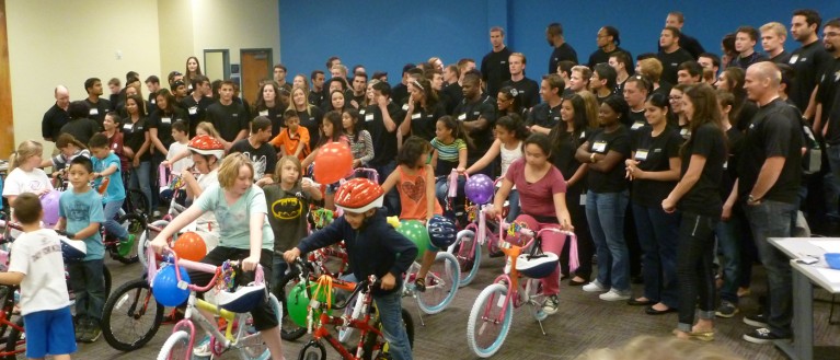 Children accepting bike-build donations
